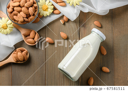 Bottle of fresh milk and Almonds nuts on wood 67581511