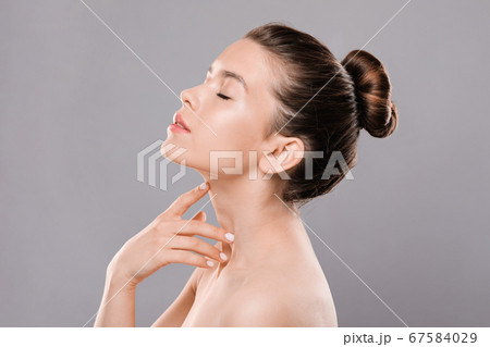 Sexual lady with closed eyes touching her neck 67584029