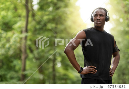 Handsome black sportsman with headset looking at copy space 67584081