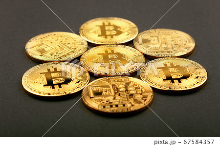 Gold bitcoin physical coins over black Gold bitcoin physical coins over black 67584357