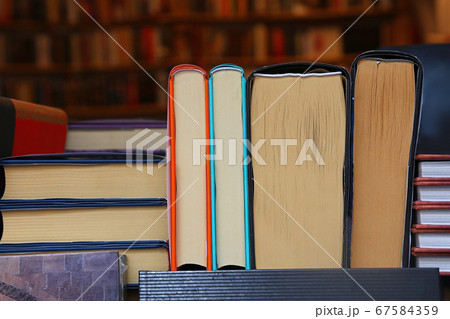 Books back on wooden shelves of store close up Books back on wooden shelves of store close up 67584359