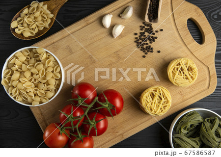 A bunch of tomatoes with italian pasta around A bunch of tomatoes with italian pasta around 67586587