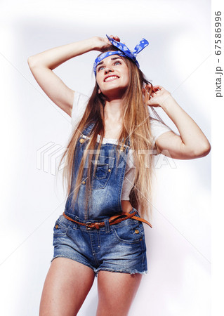 young pretty blond girl hipster posing frendly against white background wall, smiling woman with long hair young pretty blond girl hipster posing frendly against white background wall, smiling woman with long hair 67586996