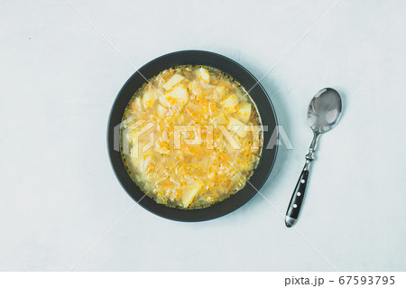 Chicken soup on black bowl on dark black stone Chicken soup on black bowl on dark black stone 67593795