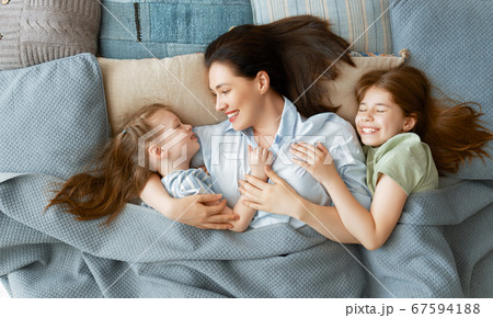 girls and their mother enjoy sunny morning 67594188