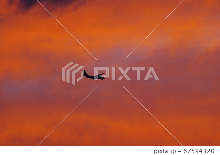 夕暮れの中を飛行するC-130ハーキュリーズ 67594320