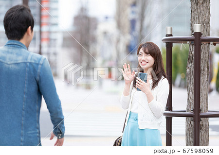 手を振る女性 67598059