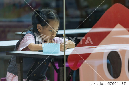 kindergarten student focused on studying kindergarten student focused on studying 67601187