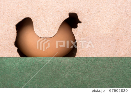 Food industry. Small business, family business. Farming background. Family business. Farming. Egg in carton box with hen cut out. Advertising of private farm with free grazing Food industry. Small business, family business. Farming background. Family business. Farming. Egg in carton box with hen cut out. Advertising of private farm with free grazing 67602820