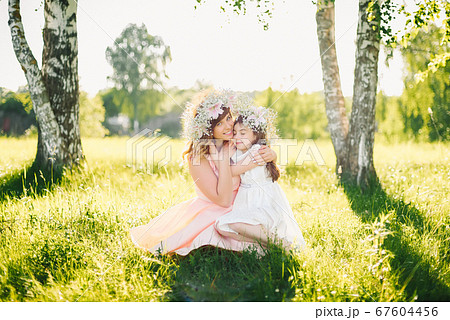 happy beautiful mother with a daughter of Caucasian appearance hugging in the meadow 67604456