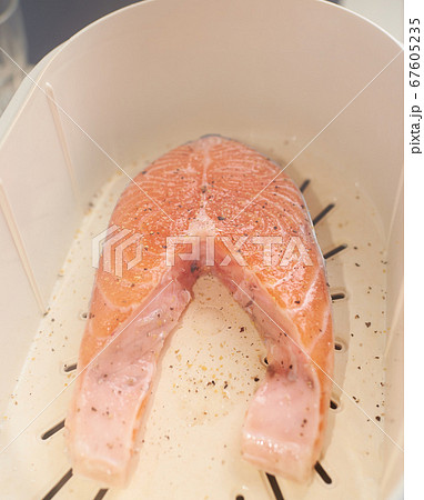 Cooking process, salmon in a double boiler, steamed. Healthy eating concept Cooking process, salmon in a double boiler, steamed. Healthy eating concept 67605235