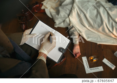 Male detective with cigar writes in notebook 67605647