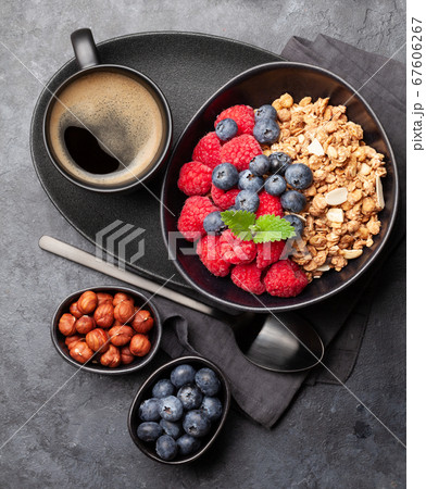 Healthy breakfast with granola, nuts and berries Healthy breakfast with granola, nuts and berries 67606267