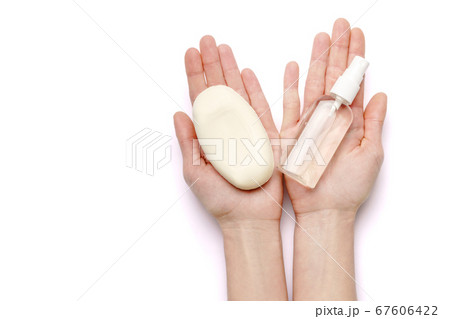 Female hands holding soap and hand sanitizer spray dispenser isolated on white background with clipping path Female hands holding soap and hand sanitizer spray dispenser isolated on white background with clipping path 67606422