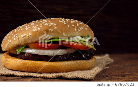 Hamburger meat and vegetables on wooden background Hamburger meat and vegetables on wooden background 67607622