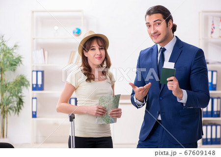 Young woman visiting embassy for visa 67609148