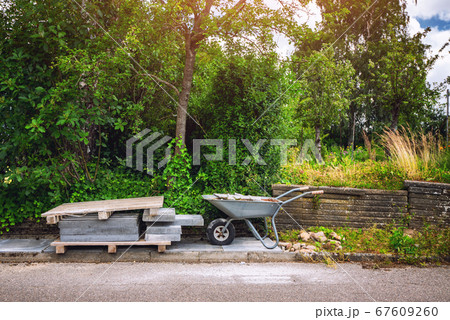 Wheelbarrow with tiles on a street 67609260