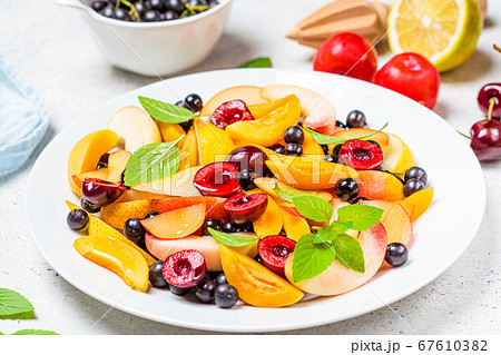 Fruit salad with berries in white plate Fruit salad with berries in white plate 67610382