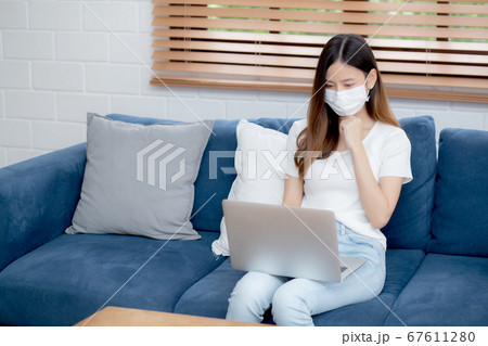 Young asian business woman in face mask work from home on laptop computer online to internet. Young asian business woman in face mask work from home on laptop computer online to internet. 67611280