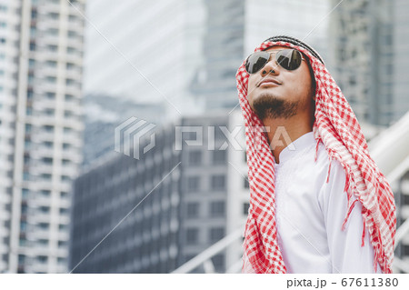Handsome modern Arabian man standing in modern 67611380