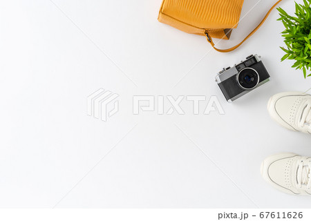 Woman lifestyle background with camera photo, purse and sneakers. Travel concept. Flat lay Woman lifestyle background with camera photo, purse and sneakers. Travel concept. Flat lay 67611626