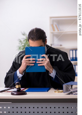 Young male judge working in courthouse Young male judge working in courthouse 67611816