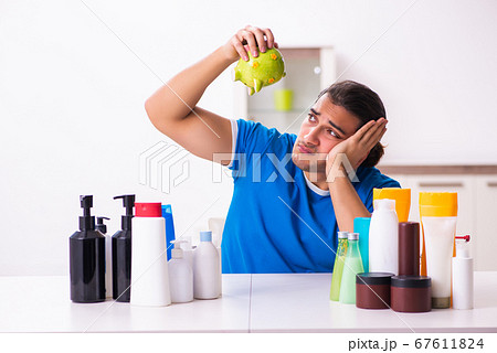 Young man selling cosmetics via internet Young man selling cosmetics via internet 67611824
