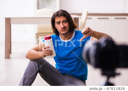 Young male sales consultant recording video for his blog Young male sales consultant recording video for his blog 67611826