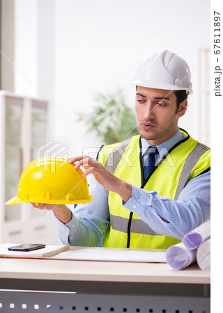 Young male architect working in the office Young male architect working in the office 67611897