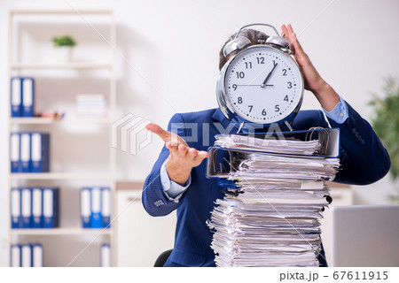 Young male employee unhappy with excessive work Young male employee unhappy with excessive work 67611915