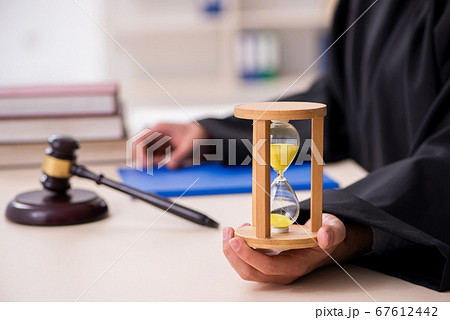 Young male judge in time management concept 67612442