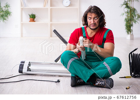 Funny young male electrician working indoors 67612756