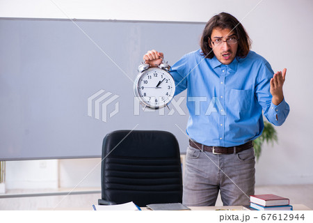 Young male teacher in the classroom 67612944