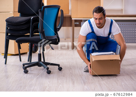 Young male professional mover doing home relocation Young male professional mover doing home relocation 67612984