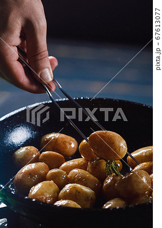 Boiled young potatoes with oil and roasted garlic, in a wooden dish. Boiled young potatoes with oil and roasted garlic, in a wooden dish. 67613077