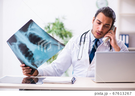 Young male handsome doctor working in the clinic 67613267