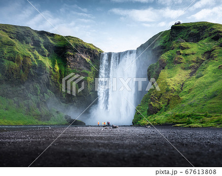 Skogafoss waterfall, Iceland. Mountain valley and clear sky. Natural landscape in summer season. Skogafoss waterfall, Iceland. Mountain valley and clear sky. Natural landscape in summer season. 67613808