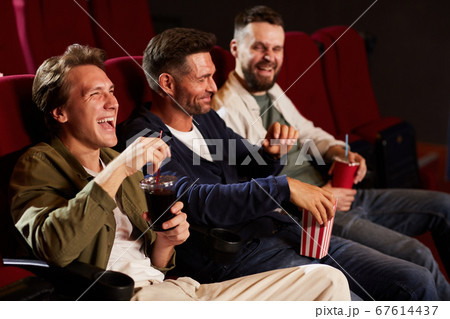 Laughing Men Watching Movie in Cinema Laughing Men Watching Movie in Cinema 67614437