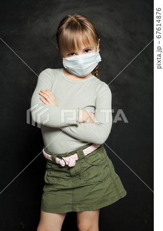 Small child girl in medical protective face mask 67614876
