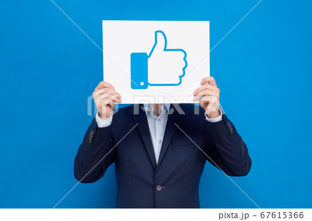 Businessman covers his face with white board Businessman covers his face with white board 67615366