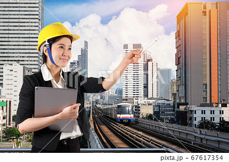 Young woman engineer holding digital tablet wtih Young woman engineer holding digital tablet wtih 67617354