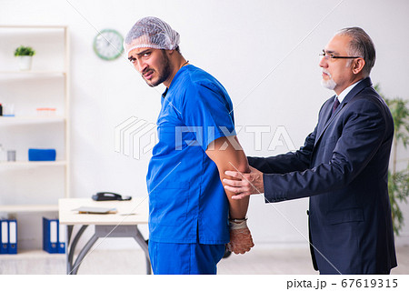 Male doctor in courthouse meeting with advocate 67619315