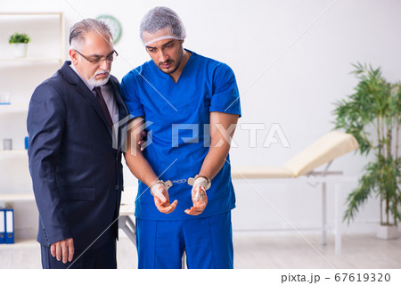 Male doctor in courthouse meeting with advocate 67619320