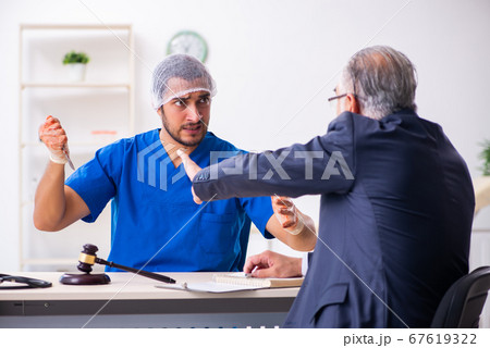 Male doctor in courthouse meeting with advocate 67619322