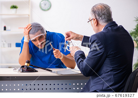 Male doctor in courthouse meeting with advocate Male doctor in courthouse meeting with advocate 67619327