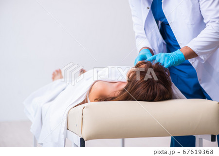 Police coroner examining dead body corpse in morgue Police coroner examining dead body corpse in morgue 67619368