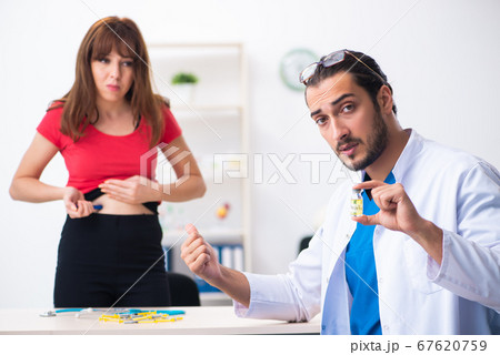 Female diabetic patient visiting young male doctor Female diabetic patient visiting young male doctor 67620759