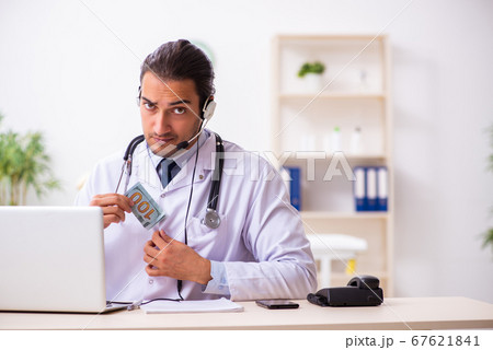 Young doctor listening to patient during telemedicine session Young doctor listening to patient during telemedicine session 67621841