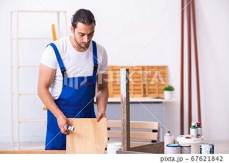 Young male contractor working in workshop Young male contractor working in workshop 67621842