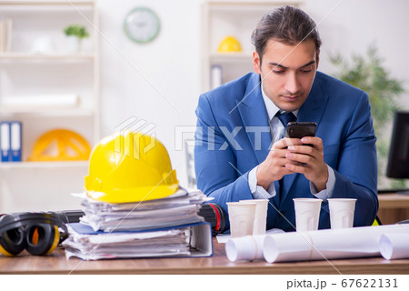 Young male architect working in the office Young male architect working in the office 67622131